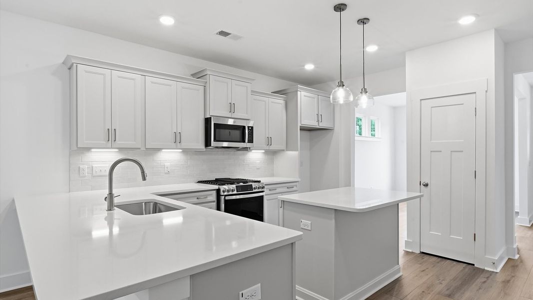 Vibrant kitchen layout with a center island, refined finishes, and open-concept flow Vibrant kitchen layout with a center island, refined finishes, and open-concept flow