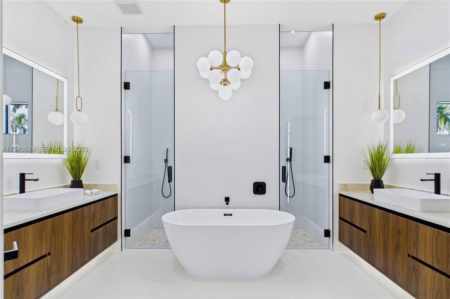 Spa-inspired bathroom w/ tiled rainfall shower, handheld showerhead, freestanding soaking tub