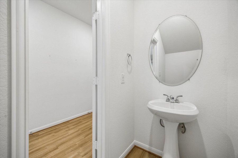 Bathroom with light wood-style floors and baseboards