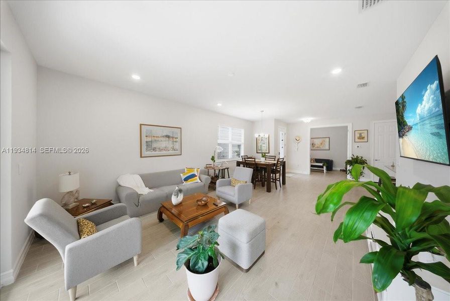 with recessed lighting and light wood-style tile flooring