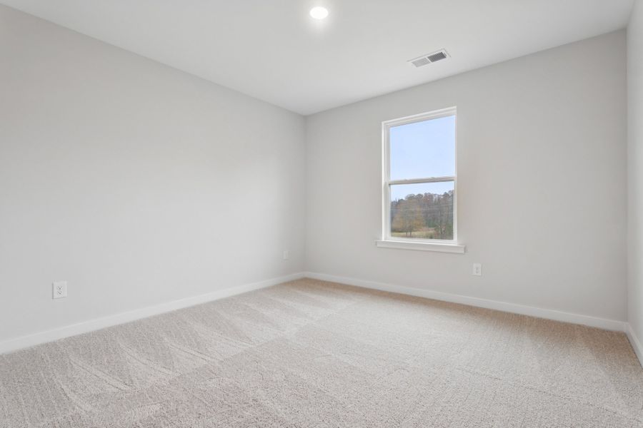 A room with a window and a carpet. A room with a window and a carpet.