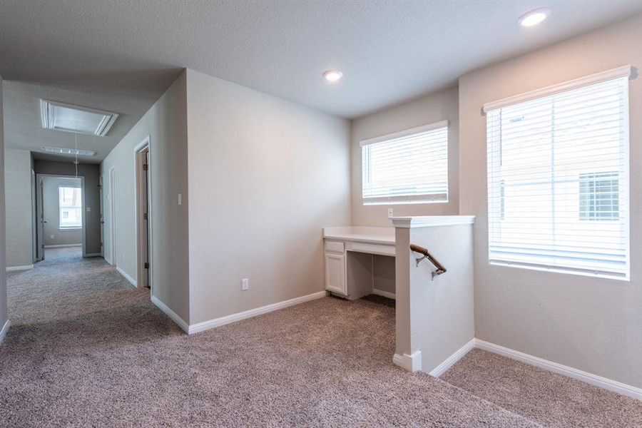 Upstairs - study desk - fully carpeted.  Door to the right houses laundry room.