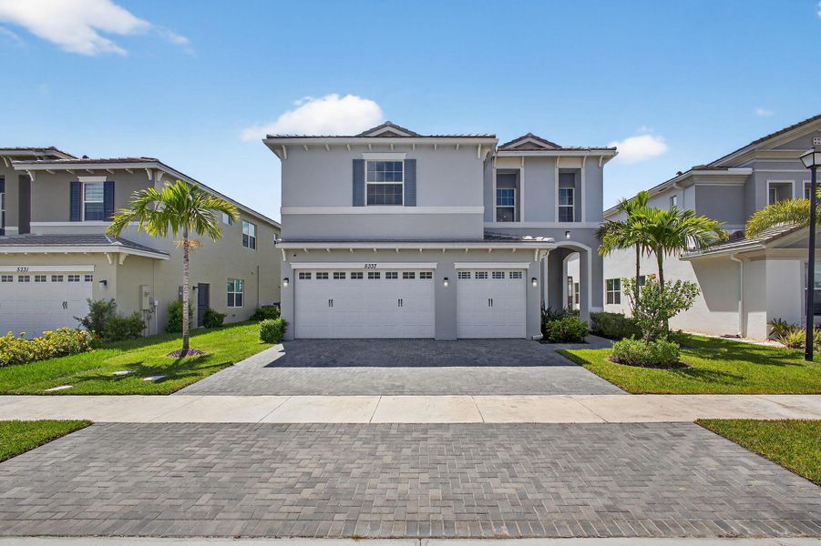 Front exterior of a new home in , The Acreage, FL, highlighting curb appeal (Image 1).