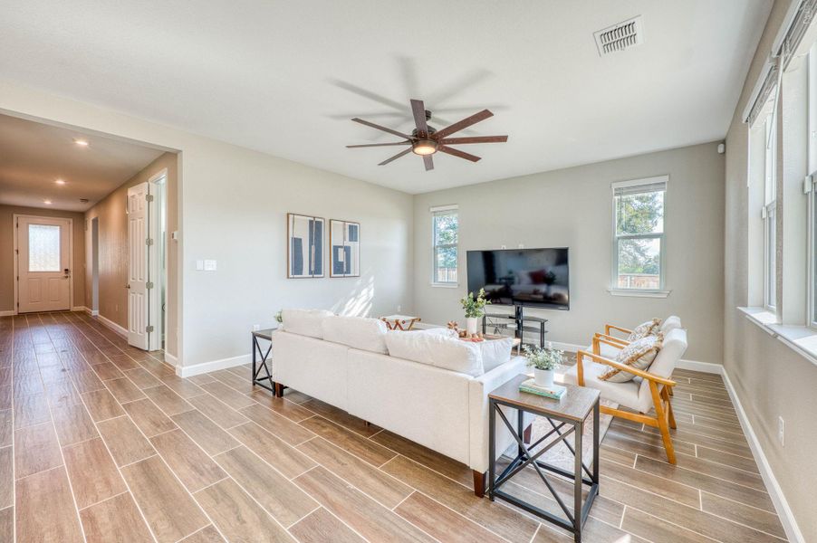 An open living area anchors the home with wood-look tile flooring and abundant natural light. An open living area anchors the home with wood-look tile flooring and abundant natural light.
