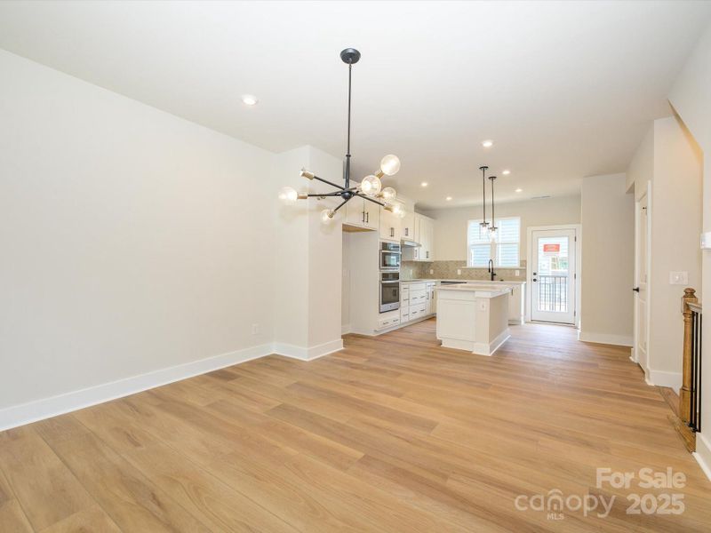 Connected Living Spaces Lit by Natural Light and Elevated Fixtures.