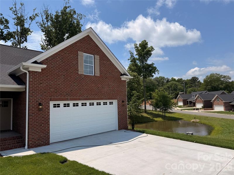 This brand new brick townhome has a 2 car garage...