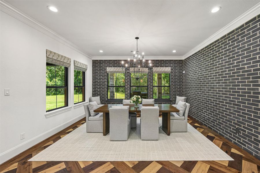 Beautiful, exquisitely designed dining room featuring a rich brick accent wall and a warm, sophisticated ambiance. Beautiful, exquisitely designed dining room featuring a rich brick accent wall and a warm, sophisticated ambiance.