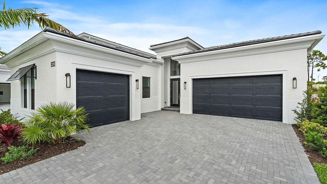 Front exterior of a new home in Artistry Palm Beach, Palm Beach Gardens, FL, highlighting curb appeal (Image 1).
