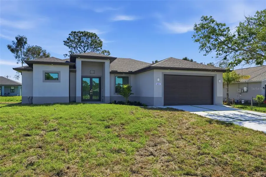 Front exterior of a new home in , Lehigh Acres, FL, highlighting curb appeal (Image 1). Front exterior of a new home in , Lehigh Acres, FL, highlighting curb appeal (Image 1).