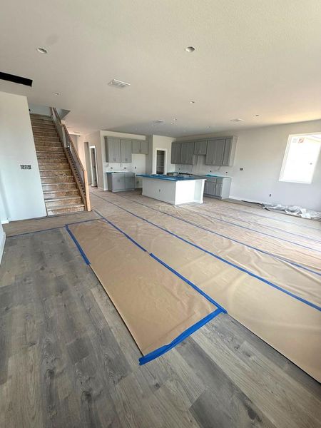 An open floorplan seamlessly connects the kitchen to a spacious living area, ideal for modern living.