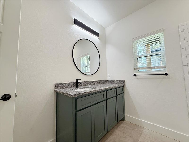 Bathroom featuring vanity and baseboards Bathroom featuring vanity and baseboards