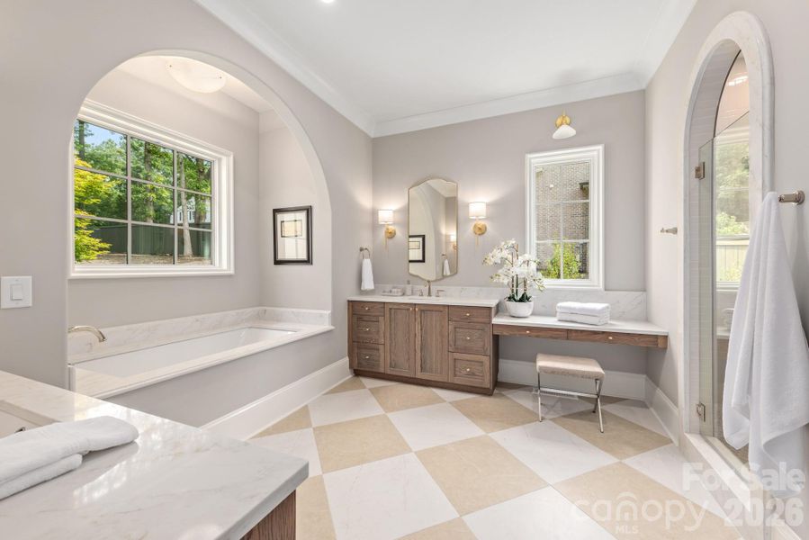 Spa bathroom with soaking tub and gorgeous wood vanities
