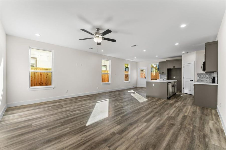 Unfurnished living room featuring recessed lighting, dark wood-style floors, and a ceiling fan Unfurnished living room featuring recessed lighting, dark wood-style floors, and a ceiling fan