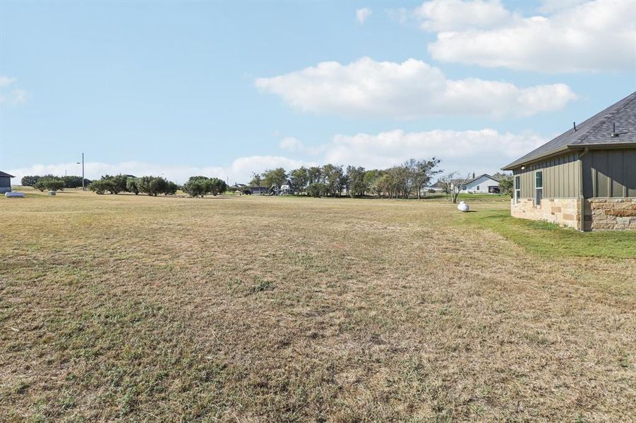 View of green lawn featuring a view of rural / pastoral area View of green lawn featuring a view of rural / pastoral area
