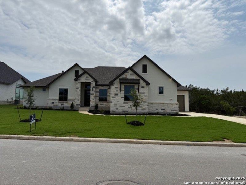 Front exterior of a new home in , Castroville, TX, highlighting curb appeal (Image 1). Front exterior of a new home in , Castroville, TX, highlighting curb appeal (Image 1).