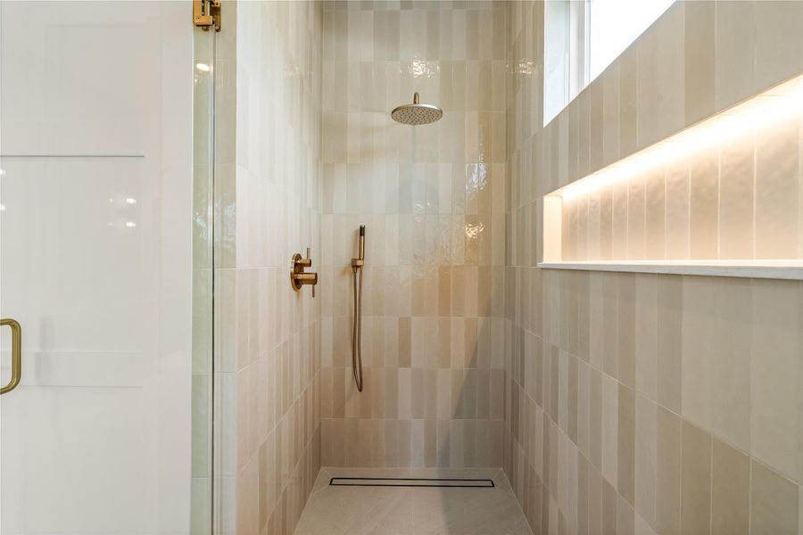 LED lit tile niche keep this shower both practical and quietly luxurious, with a linear drain that keeps the whole space feeling clean and modern. It's a detail-level upgrade most homes skip.