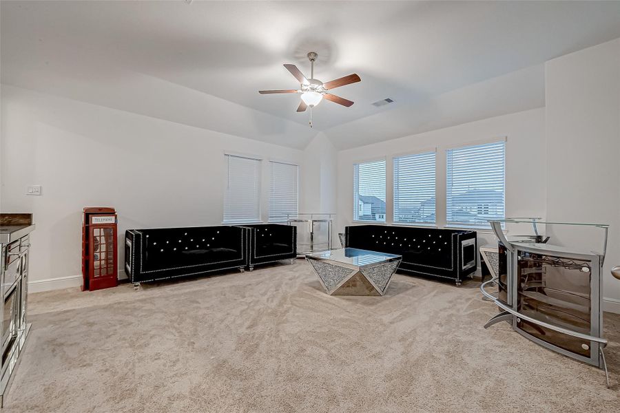 Game Room: Spacious with a wall of windows, accessible to Balcony overlooking the backyard.