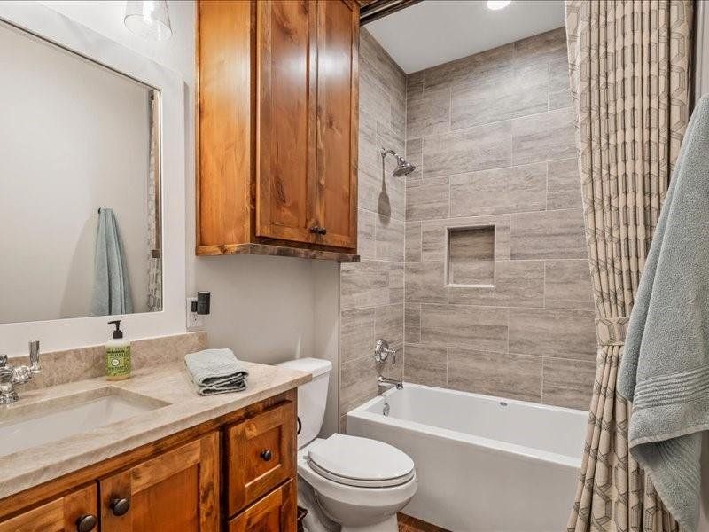 Hall bathroom with quartzite countertops and custom shower curtain.  Custom cabinets of course.
