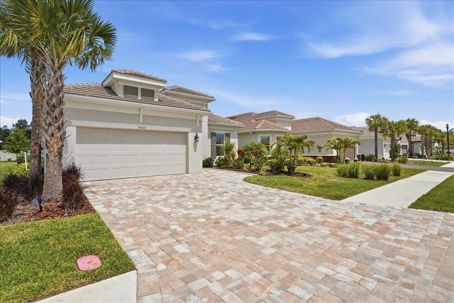 Front exterior of a new home in Esplanade at Artisan Lakes, Palmetto, FL, highlighting curb appeal (Image 22).