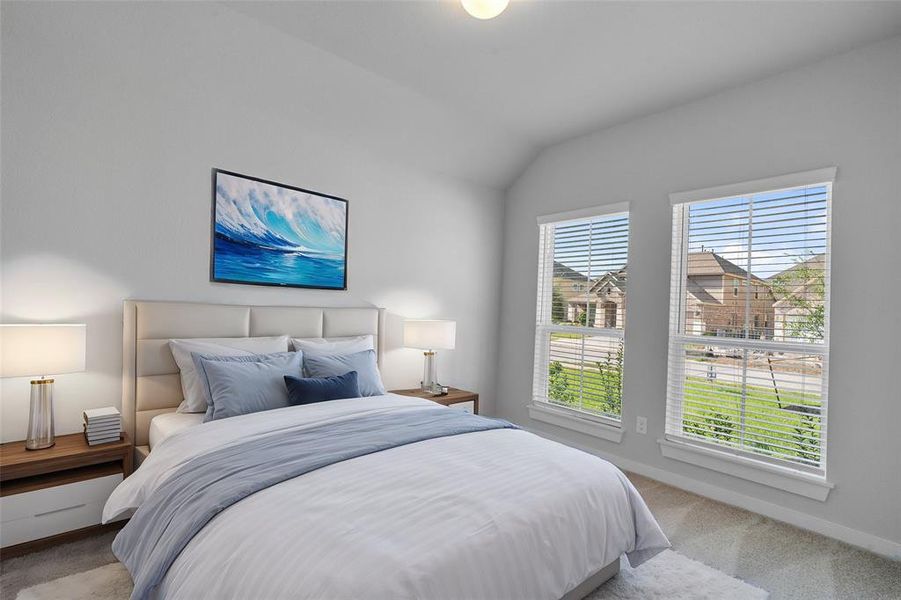 Secondary bedroom features plush carpet, neutral paint, lighting and large windows with privacy blinds.