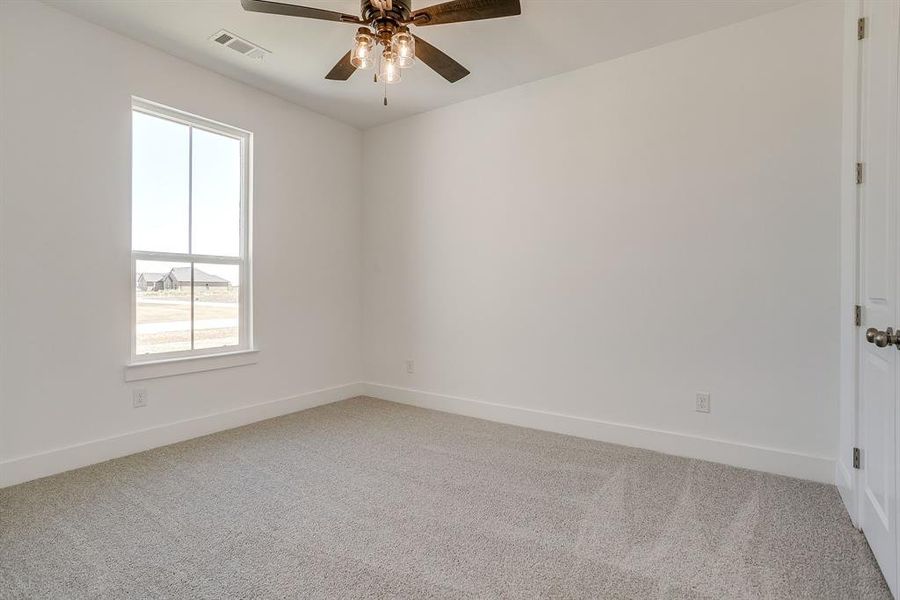 Spare room with light colored carpet and ceiling fan Spare room with light colored carpet and ceiling fan