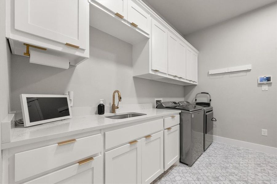 Spacious laundry room with sink & built-ins
