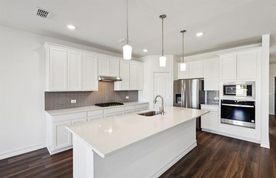 Bright kitchen with oversized island *real home pictured