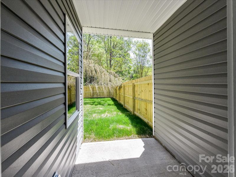 Covered patio overlooks a private fenced backyard, creating the perfect setting for outdoor dining, relaxing, or entertaining year-round.