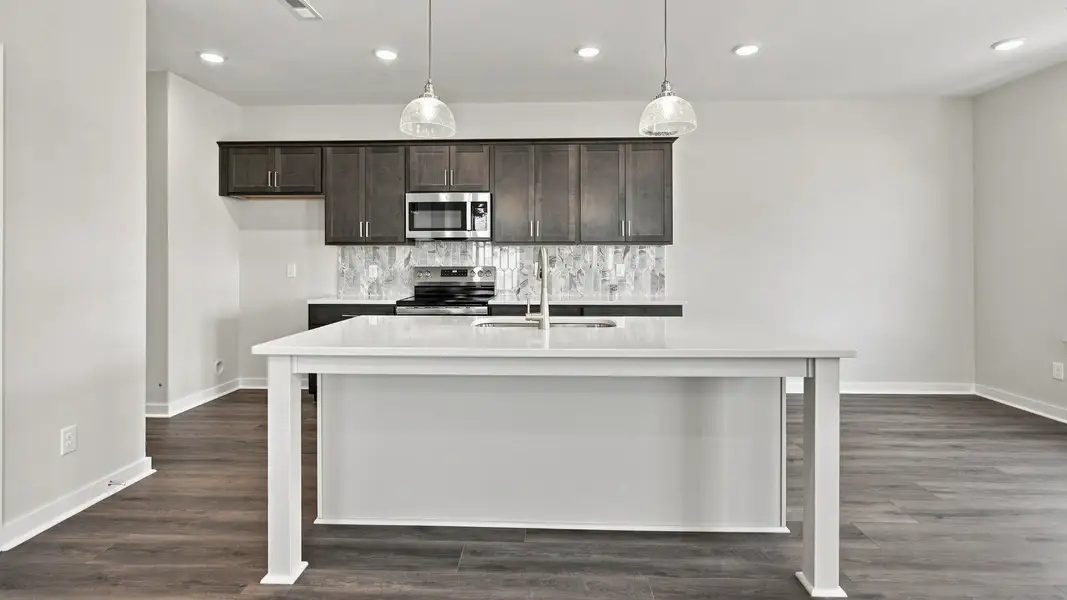 Kitchen with island and convenient cabinets with various dining areas