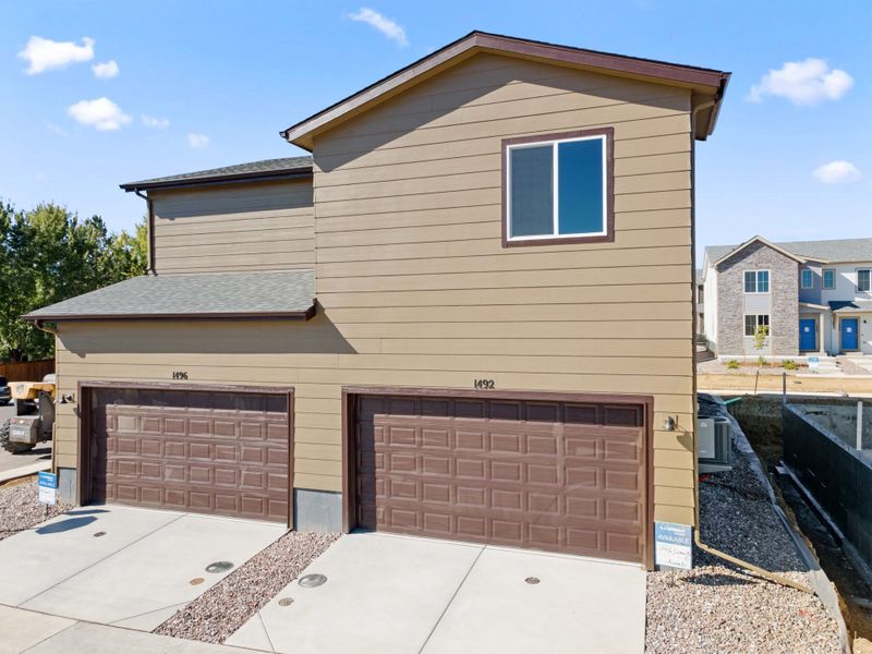 Front exterior of a new home in Spring Valley, Longmont, CO, highlighting curb appeal (Image 2).