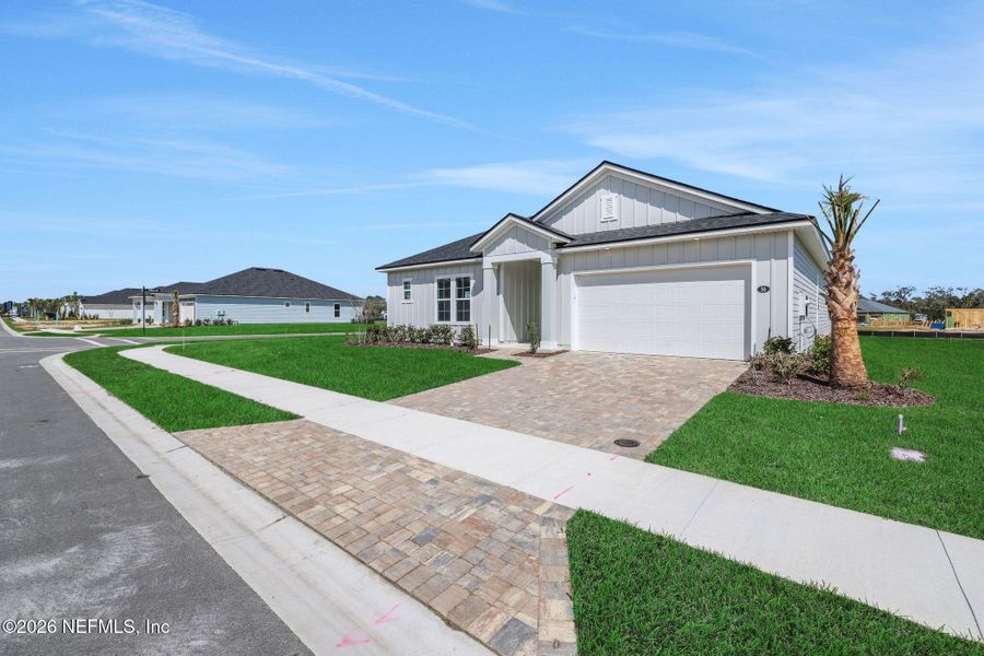 Front exterior of a new home in Veranda Bay, Flagler Beach, FL, highlighting curb appeal (Image 23).