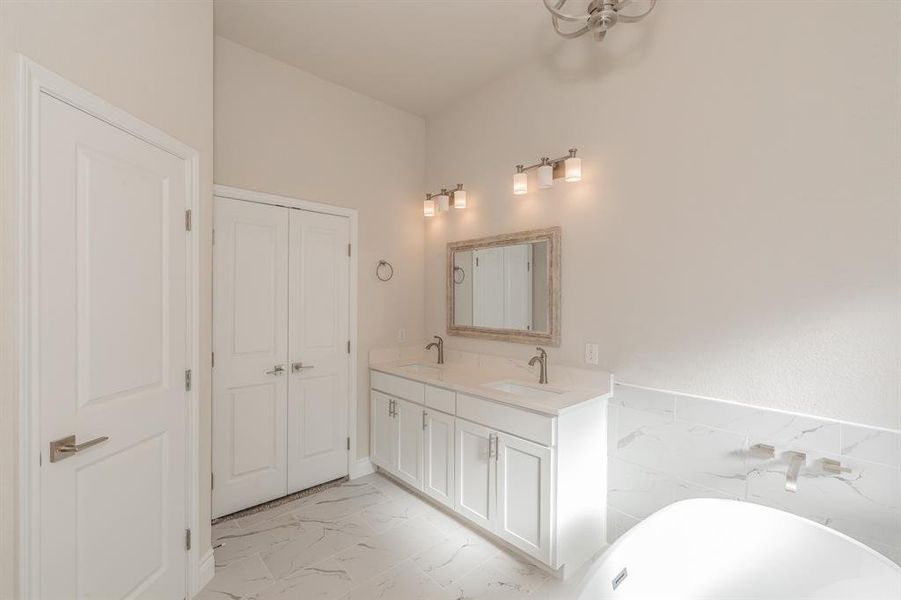 Bathroom featuring a tub and vanity