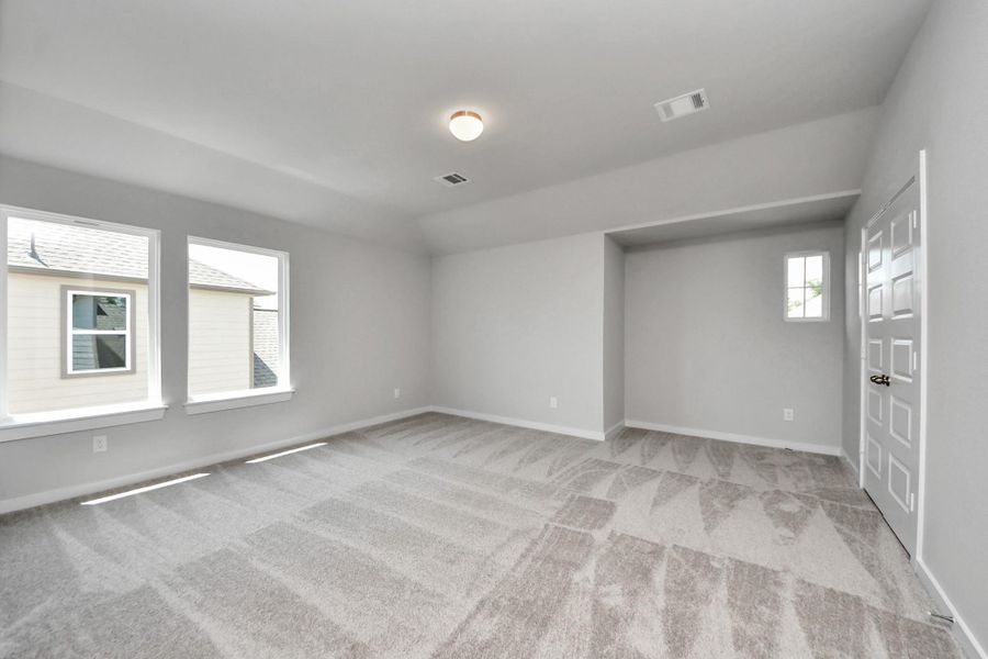 Generously sized secondary bedrooms featuring spacious closets, soft and inviting carpeting underfoot, large windows allowing plenty of natural light, and the added touch of privacy blinds for your personal retreat. Sample photo of completed home with similar floor plan. Actual colors and selections may vary.