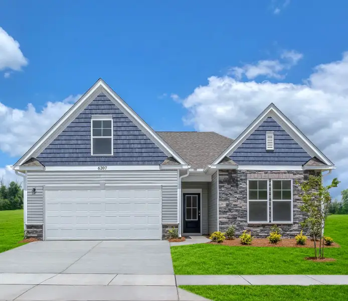 Front exterior of a new home in Bell Meadows, Winnabow, NC, highlighting curb appeal (Image 21).