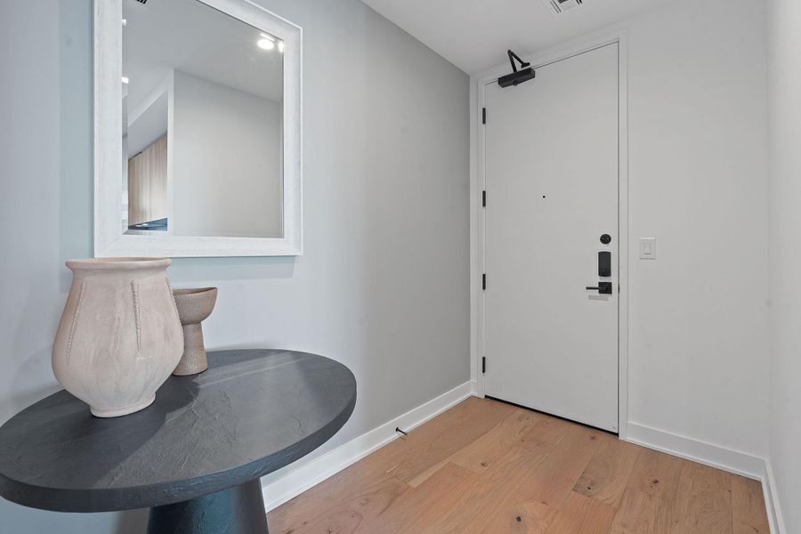 Representative photo. Entrance foyer with hardwood flooring and recessed lighting