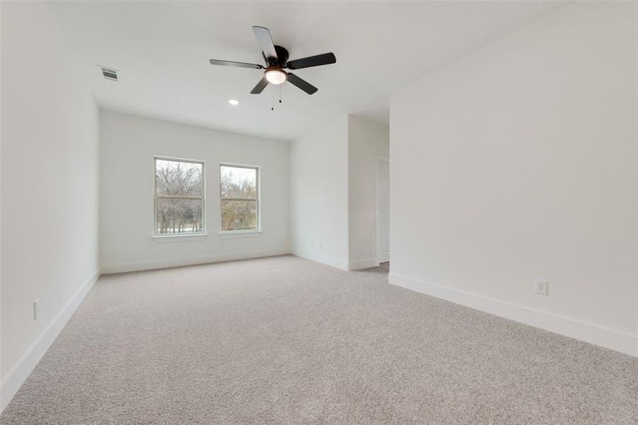 Spare room featuring recessed lighting, light colored carpet, a ceiling fan, baseboards, and visible vents