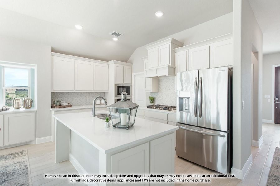Kitchen with white cabinets, center island with sink, and stainless steel refrigerator and appliances Kitchen with white cabinets, center island with sink, and stainless steel refrigerator and appliances