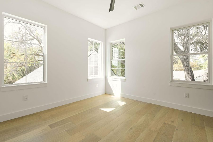 Spare room featuring light wood-type flooring and baseboards Spare room featuring light wood-type flooring and baseboards