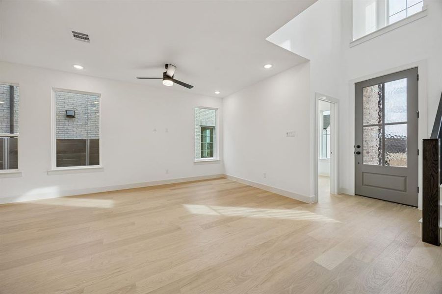 Your new family room offers lovely wood look flooring with plenty of windows to fill the space with natural light.