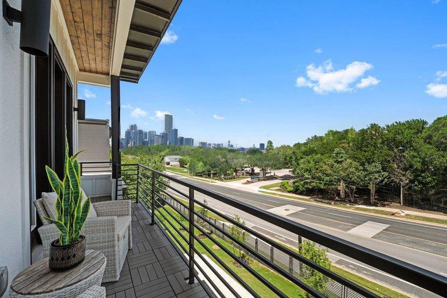 Private balcony accessed from the primary bedroom  with stunning views of the city skyline.