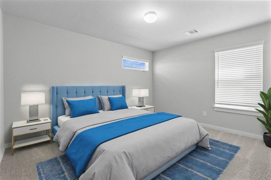 Secondary bedroom features plush carpet, neutral paint and a large window with privacy blinds.