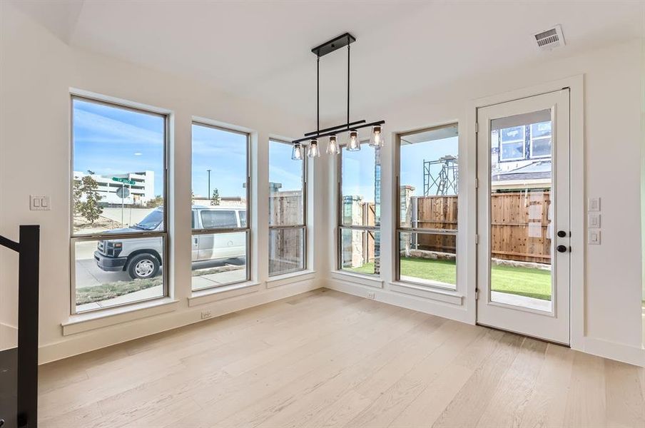 Unfurnished sunroom featuring plenty of natural light