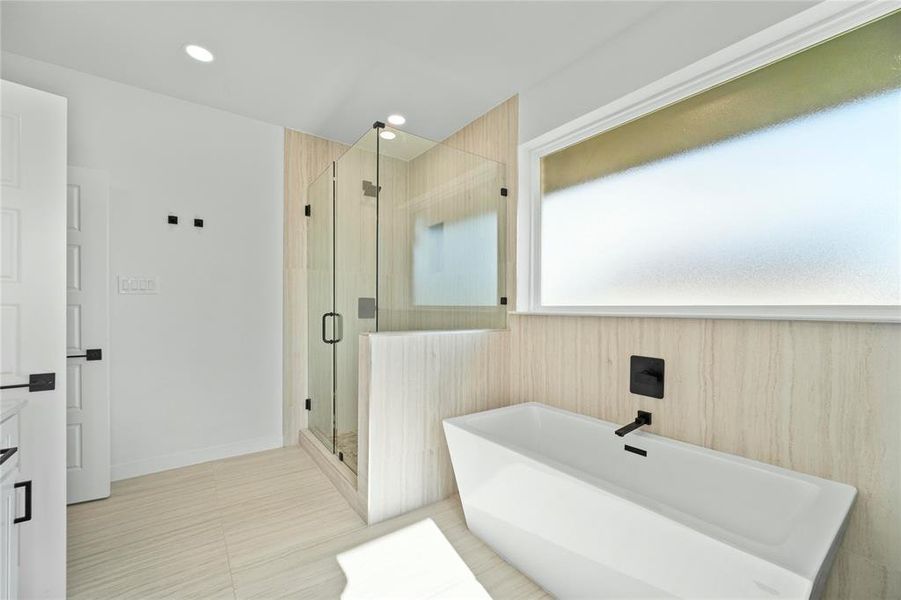 Full bath featuring a soaking tub, a stall shower, vanity, and recessed lighting Full bath featuring a soaking tub, a stall shower, vanity, and recessed lighting