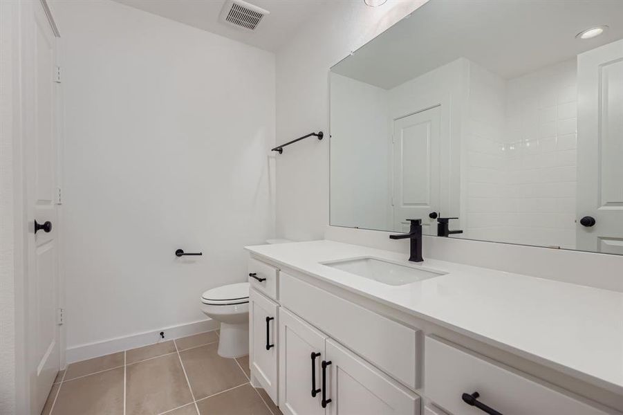 Full bathroom featuring vanity, light tile patterned floors, and recessed lighting