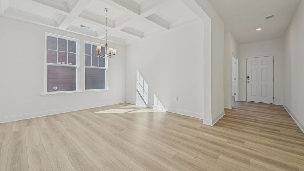 Wagener home plan formal dining room with coffered ceilings adjacent to front entry