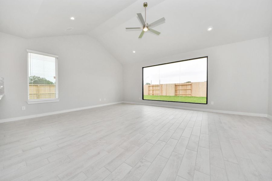 Welcome family and guests to your charming living room! With its high ceilings, recessed lighting, ceiling fan, custom paint, beautiful flooring, and large windows that let in abundant natural light, this room is perfect for gatherings. Sample photo of completed home with similar floor plan. Actual colors and selections may vary. Welcome family and guests to your charming living room! With its high ceilings, recessed lighting, ceiling fan, custom paint, beautiful flooring, and large windows that let in abundant natural light, this room is perfect for gatherings. Sample photo of completed home with similar floor plan. Actual colors and selections may vary.