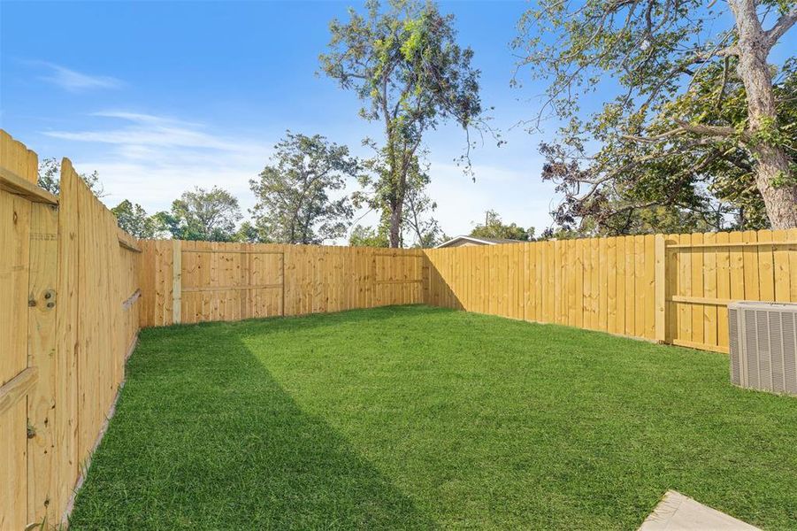 This backyard is completely fenced-in. There’s room for the dog to run around, with plenty of space to lounge, host BBQ, and entertain.