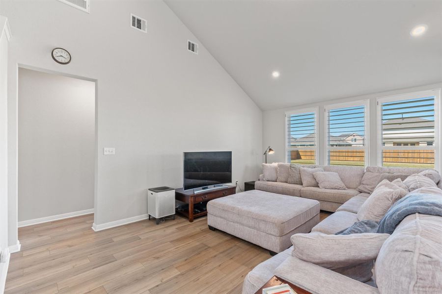 Bright living room with high vaulted ceilings.