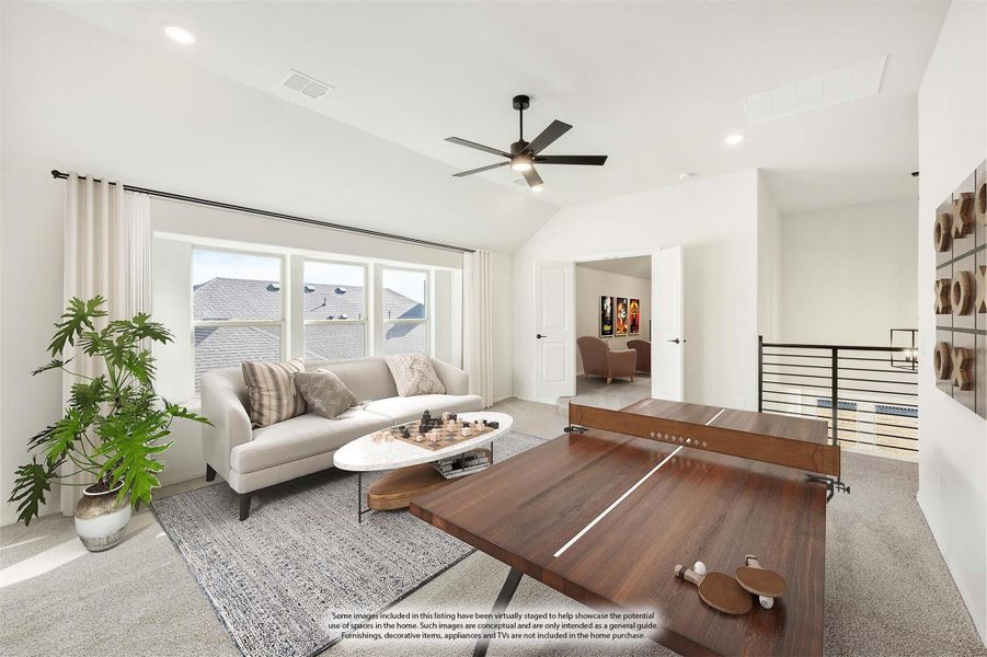 Upstairs game room with ping pong table, sofa, ceiling fan, and vaulted ceiling over carpeted floor