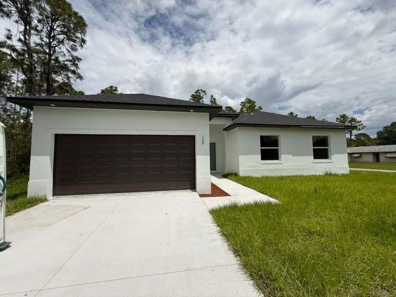 Front exterior of a new home in , Lehigh Acres, FL, highlighting curb appeal (Image 2). Front exterior of a new home in , Lehigh Acres, FL, highlighting curb appeal (Image 2).
